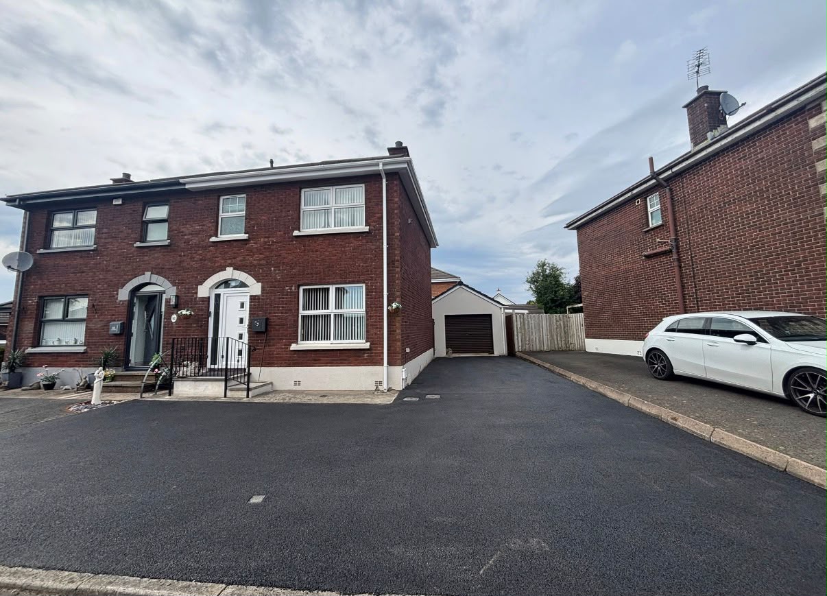 Freshly laid tarmac driveway with brick edging